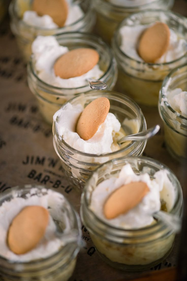 small jars filled with whipped cream and cookies