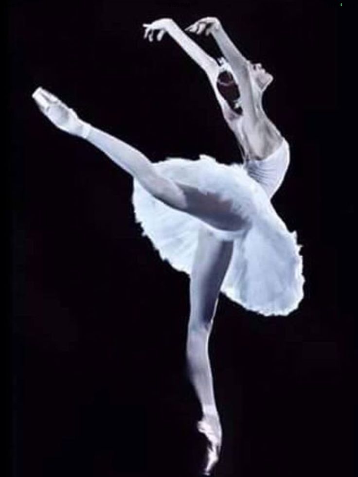 the ballerina is dressed in white and posing