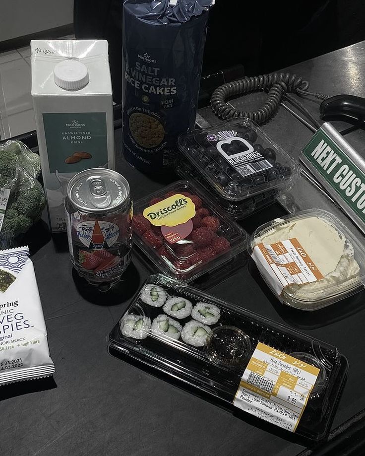 some food is laying out on a table next to a bag of ice cream and other items