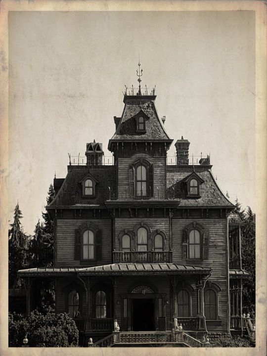 an old photo of a large house with lots of windows