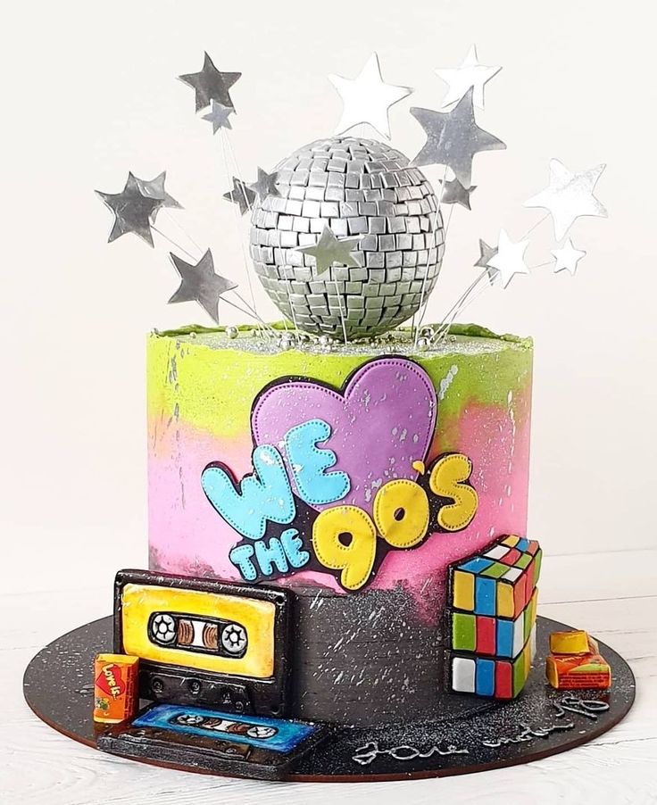 a birthday cake decorated with disco balls and stars