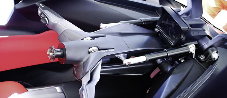 the interior of a sports car with red and black accessories on it's dashboard