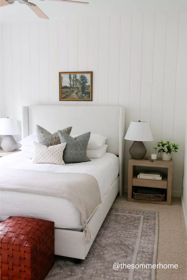 a bedroom with white walls and wood paneling