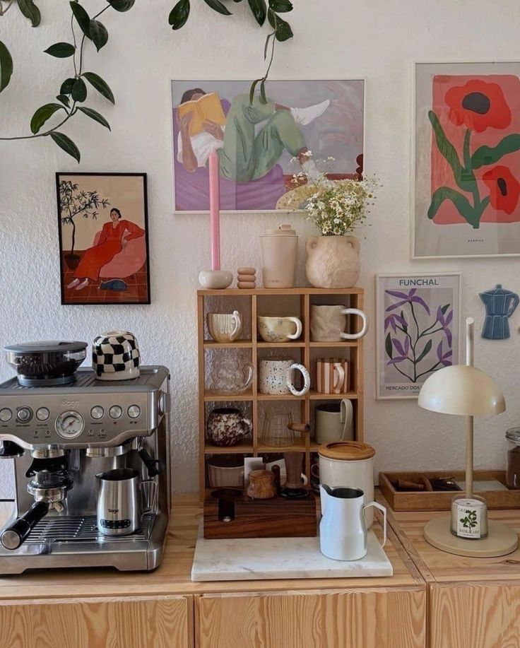 a coffee maker sitting on top of a counter next to a shelf filled with cups and saucers