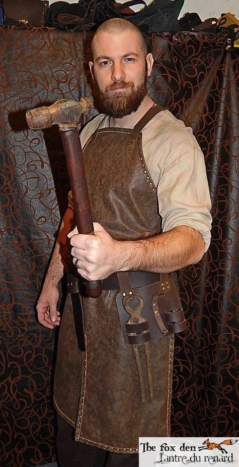 a man in an apron holding a large hammer