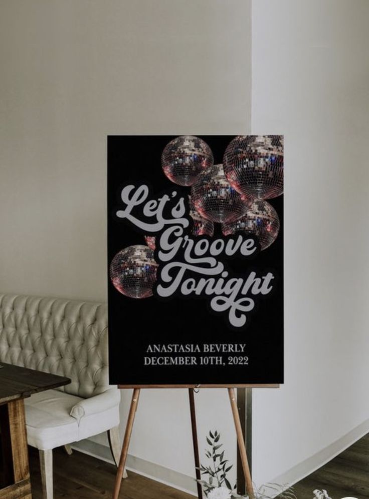 a black and white sign that says let's grove tonight with some shiny balls on it