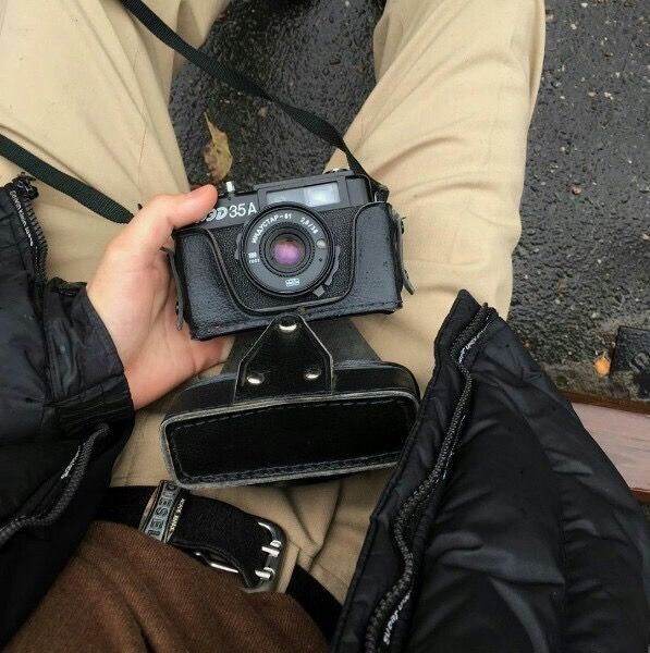 a person holding a camera in their lap