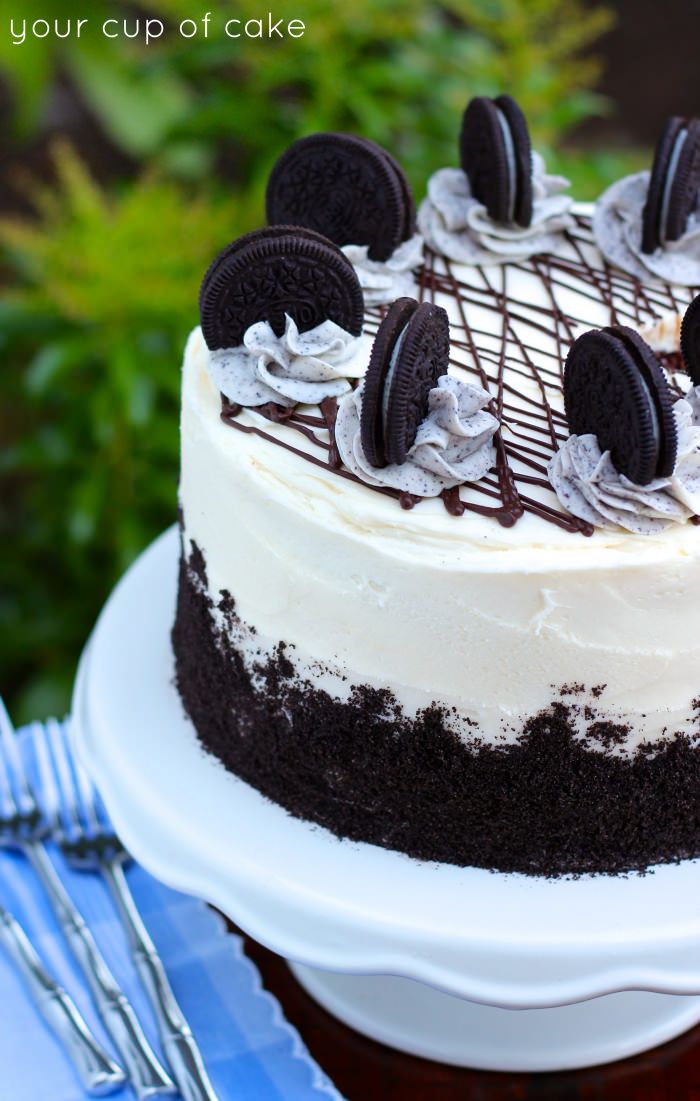 an oreo cookie cake with white frosting and chocolate cookies on top is shown