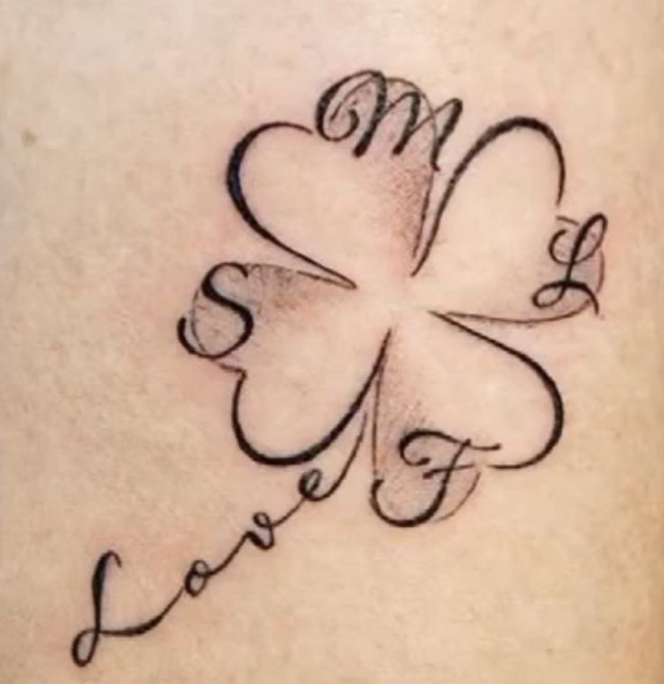 a four leaf clover with the word love written on it's side ribcage