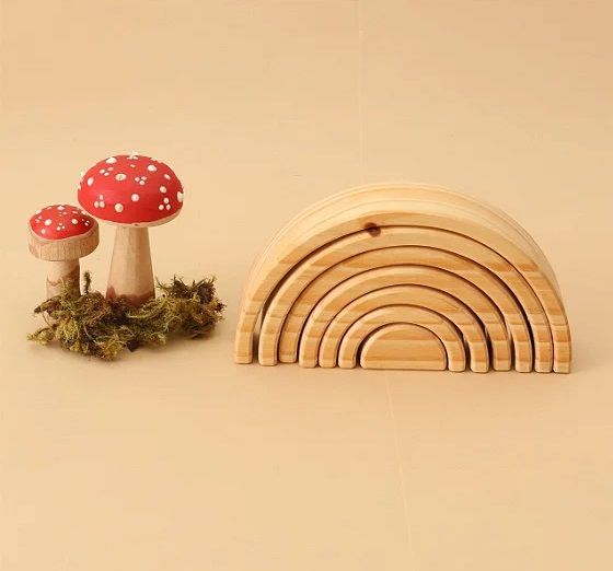 a wooden toy set with mushrooms and rainbows