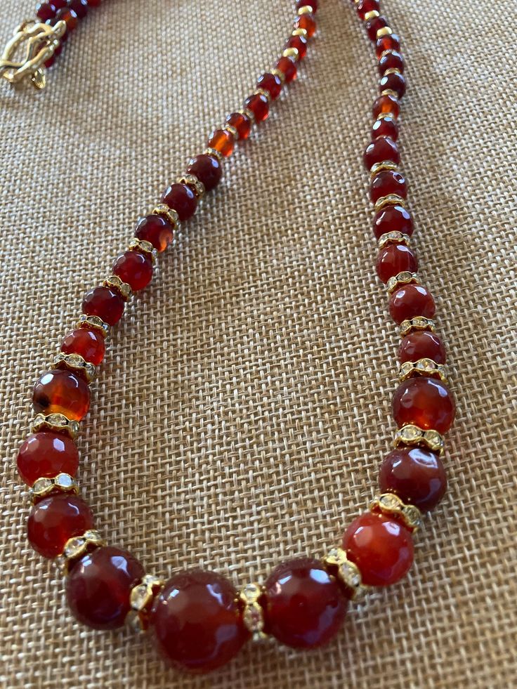 Handmade necklace made with Carnelian beads and golden spacers   Beautiful addition to any collection. Fall colors. One of a kind. Luxury Beaded Carnelian Necklace, Luxury Elegant Carnelian Beaded Necklaces, Gold Agate Beaded Necklaces With Faceted Beads, Vintage Beaded Carnelian Necklace, Vintage Carnelian Beaded Necklace, Gold Agate Single Strand Beaded Necklace, Gift Carnelian Faceted Beads, Vintage Adjustable Carnelian Necklace, Beaded Carnelian Round Beads Necklace