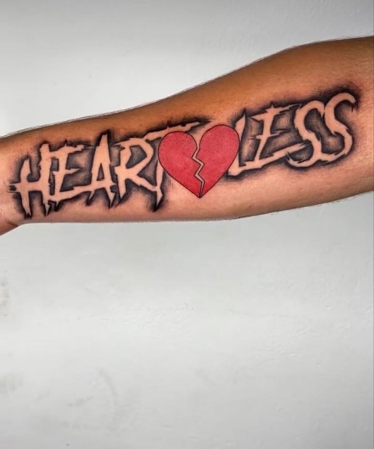 a man's arm with the word heartless written on it