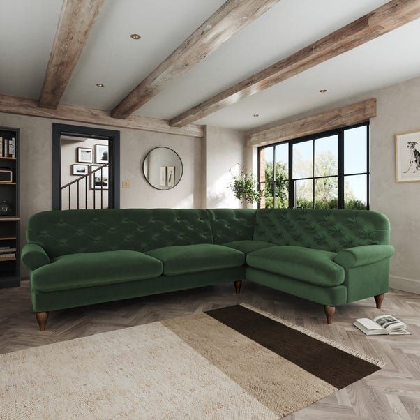 a living room with a large green couch