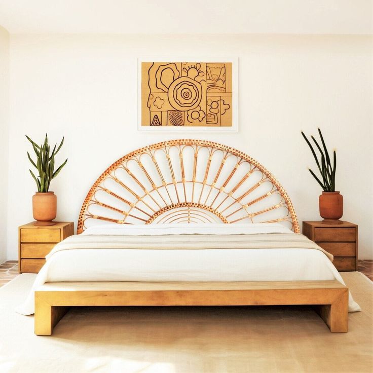 a bamboo bed frame with white sheets and pillows in a modern style bedroom, with potted plants on either side