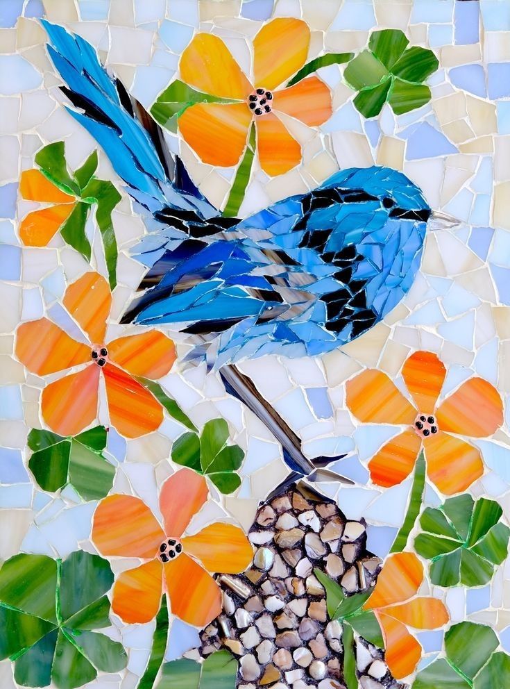 a blue bird sitting on top of a flower covered ground next to orange and yellow flowers