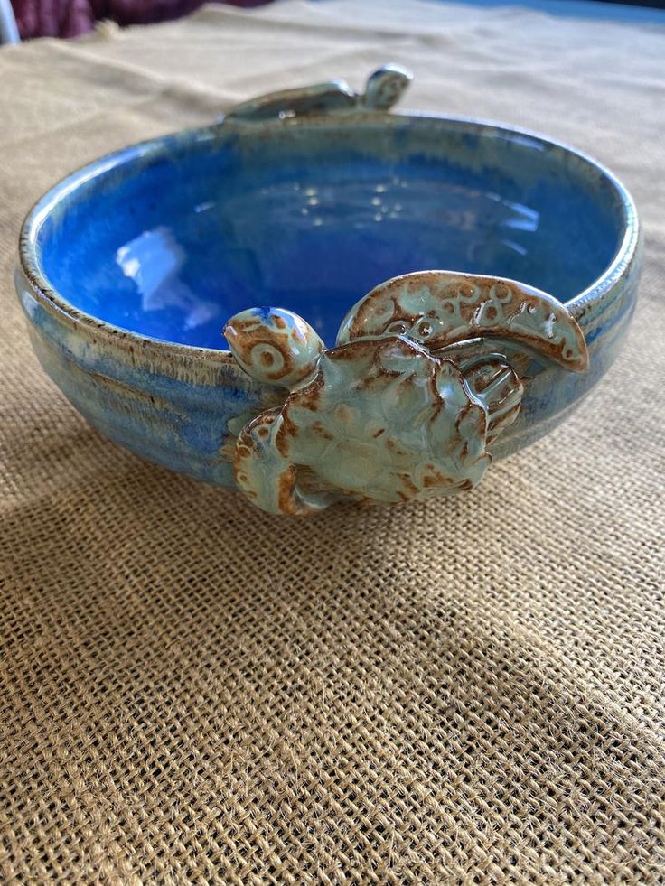 a blue bowl sitting on top of a table