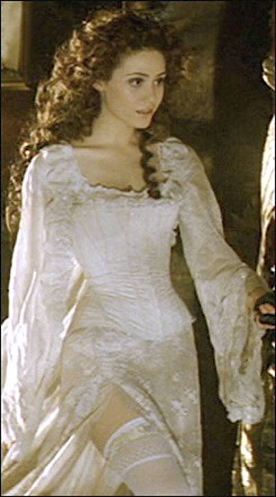 an image of a woman in white dress with long sleeves and lace on her shoulders