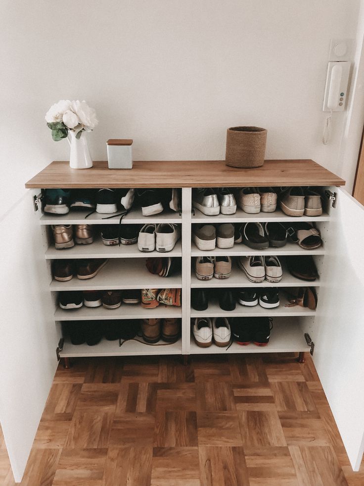 there are many pairs of shoes on the shelf next to each other in this room