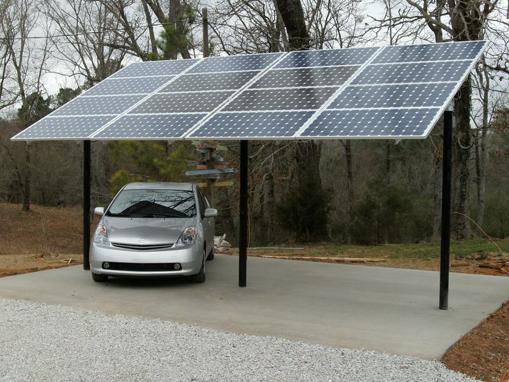 a car is parked under a solar panel