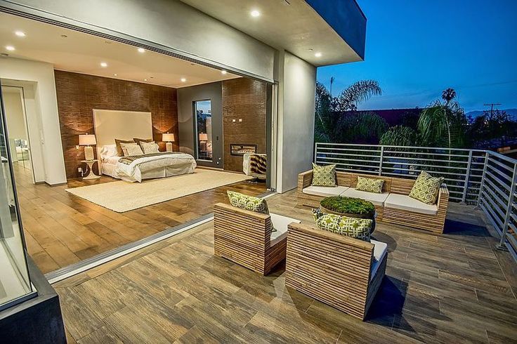 a large bedroom with wooden floors and furniture