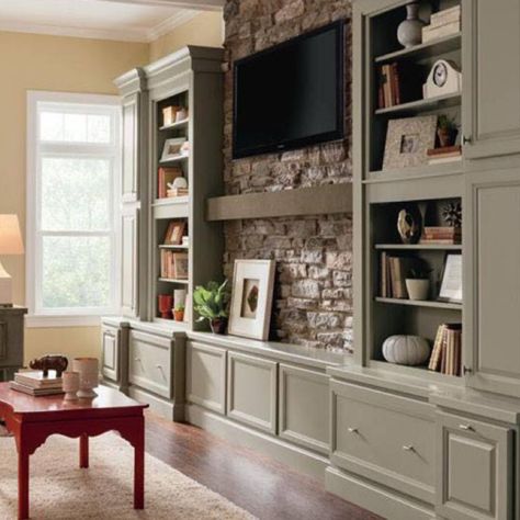 a living room filled with furniture and a flat screen tv mounted on a wall above a fireplace