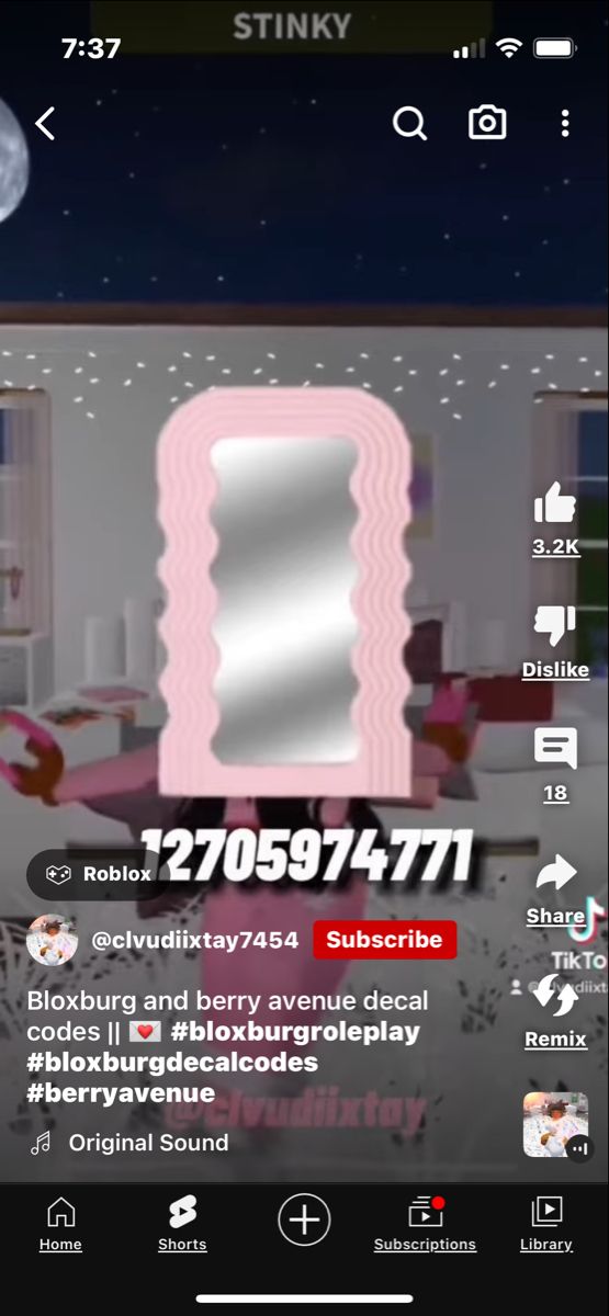 an image of a room with pink walls and white furniture in the foreground, on a cell phone screen