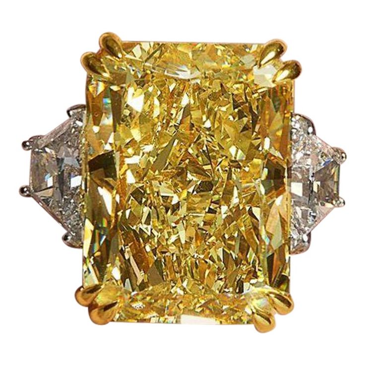 This stunning engagement ring boasts a magnificent centerpiece: a GIA certified 10 carat fancy yellow diamond solitaire. The diamond's fancy yellow color grade radiates a captivating and vibrant hue, imbuing the ring with a sense of unparalleled elegance and charm. Certified by the Gemological Institute of America (GIA), the diamond exhibits exceptional clarity, graded as VVS1, ensuring remarkable transparency and brilliance. Its surface is meticulously polished to perfection, with both polish and symmetry rated as excellent, resulting in a dazzling display of light reflection and dispersion. Notably, the diamond exhibits faint fluorescence, allowing its natural beauty to shine forth with pure brilliance. This ring serves as a timeless symbol of love and commitment, embodying the essence o Faint Yellow Diamond Engagement Ring, Yellow Diamonds Engagement, Canary Diamond, Yellow Diamond Engagement Ring, Fancy Yellow Diamond, Yellow Jewelry, Stunning Engagement Ring, Neon Purple, Fine Jewels