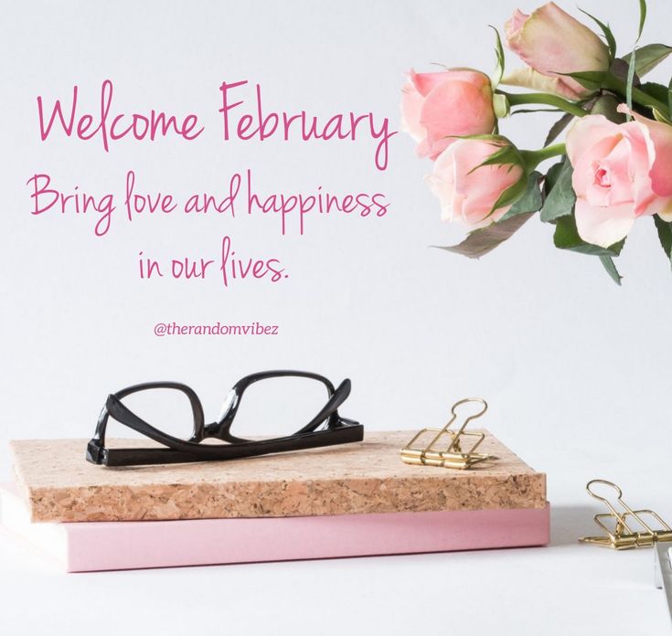 a pair of black glasses sitting on top of a book next to pink flowers and a pen