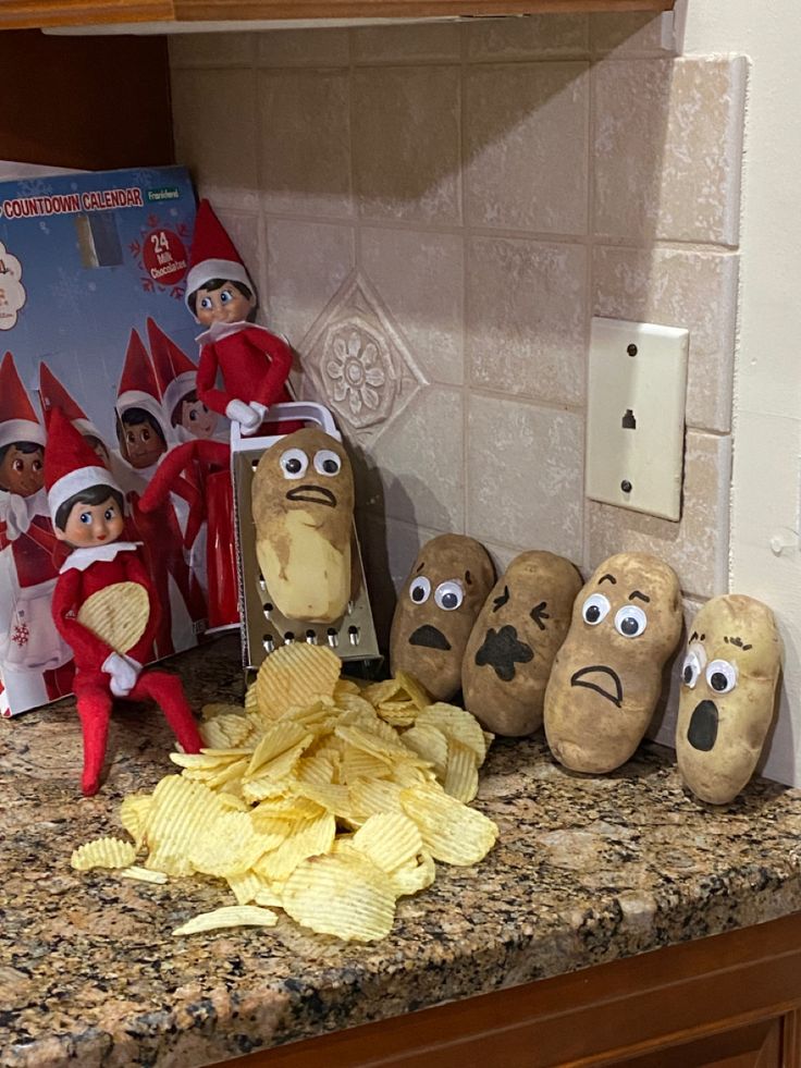 an elf is sitting on the counter next to some potato chips