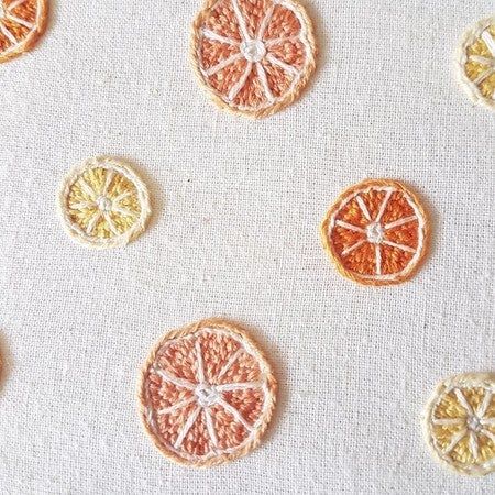 orange slices are arranged on a white surface