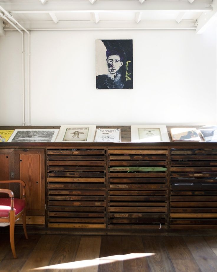 an old wooden cabinet with pictures on it