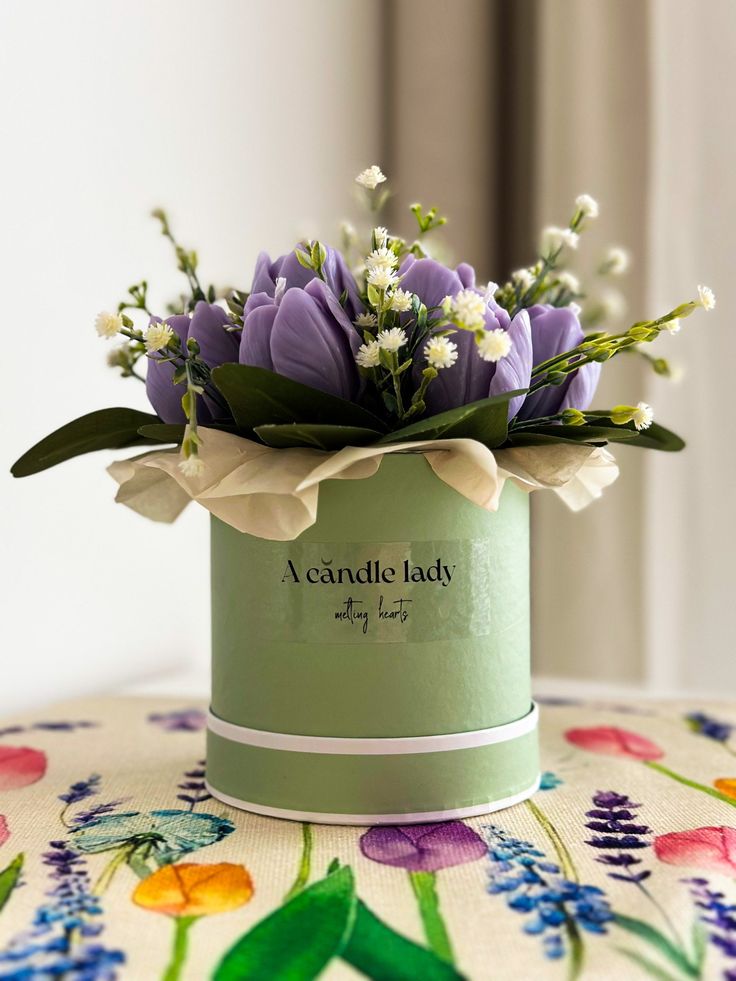 a flower pot with flowers in it sitting on a table