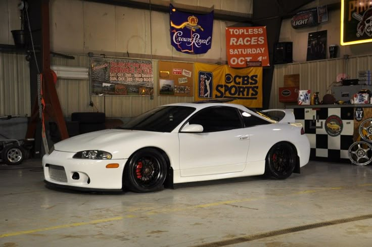 a white sports car parked in a garage