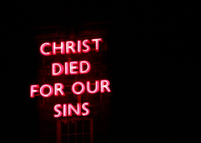 a neon sign that says christ died for our sin's