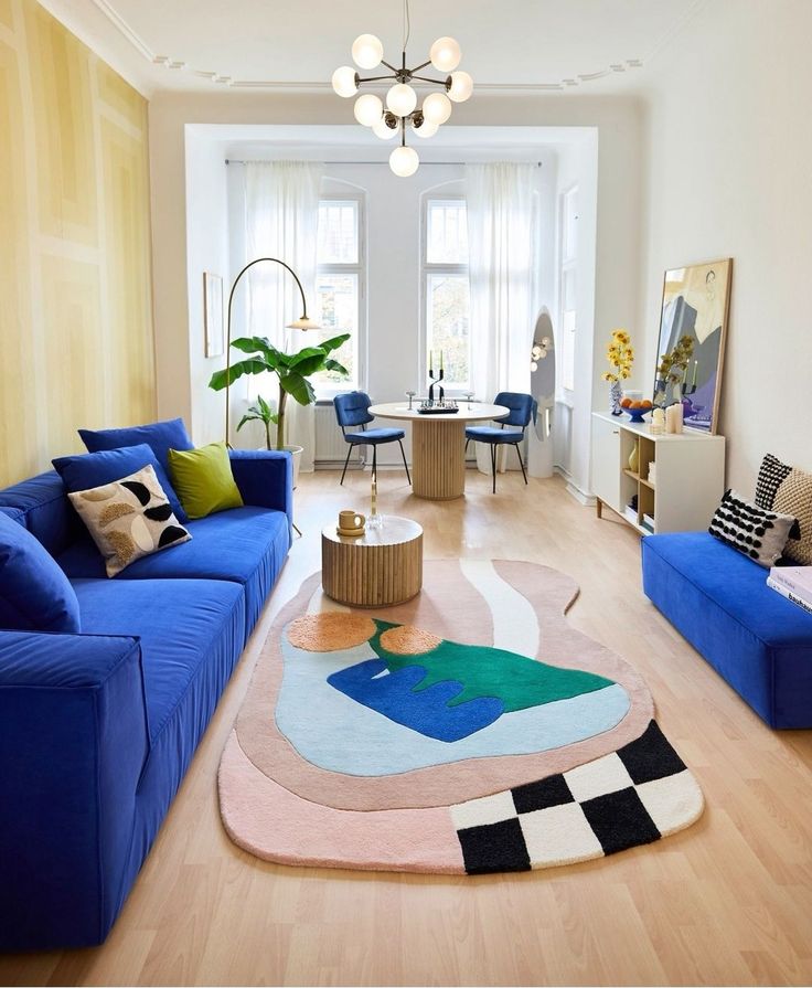 a living room filled with blue couches and furniture