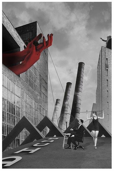 black and white photograph of people standing in front of tall buildings with giant red objects