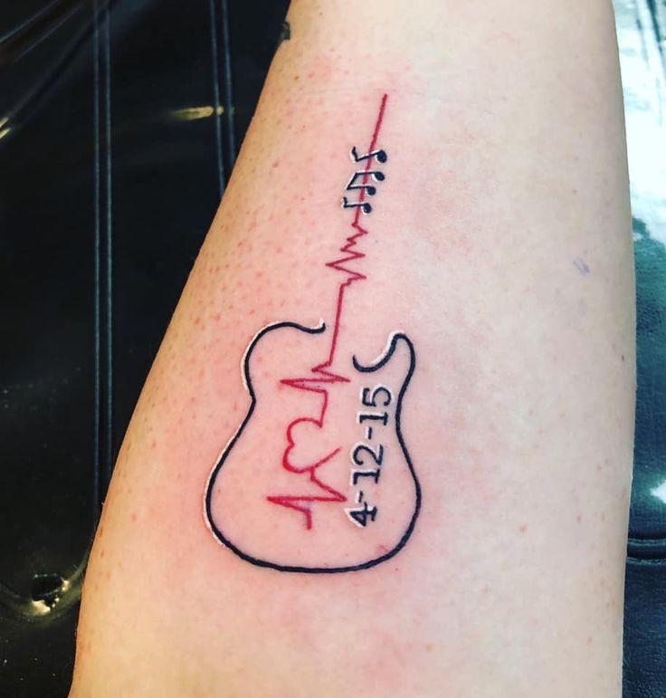 a tattoo on the arm of a person with a guitar and heartbeat beat sign in red ink