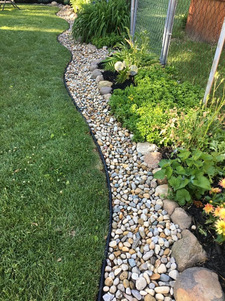 a garden with rocks and grass in it