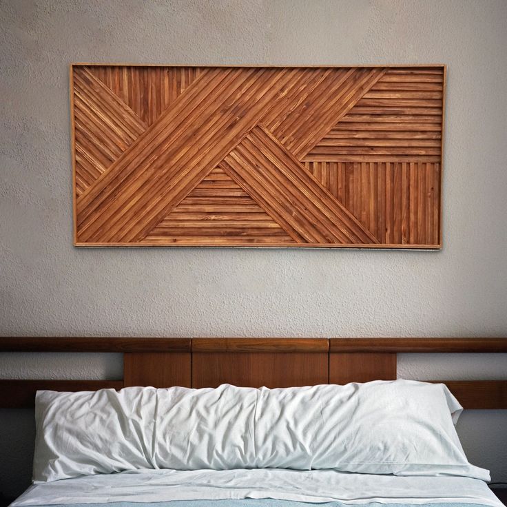 a bed with a wooden head board above it