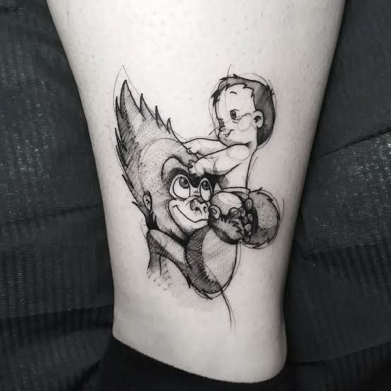 a tattoo on the leg of a person with an animal and man hugging each other