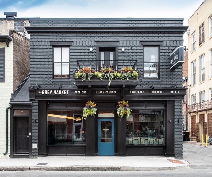 a black building with plants on the windows