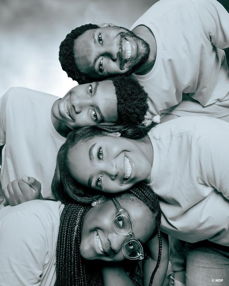 a group of people that are laying down on top of each other in black and white