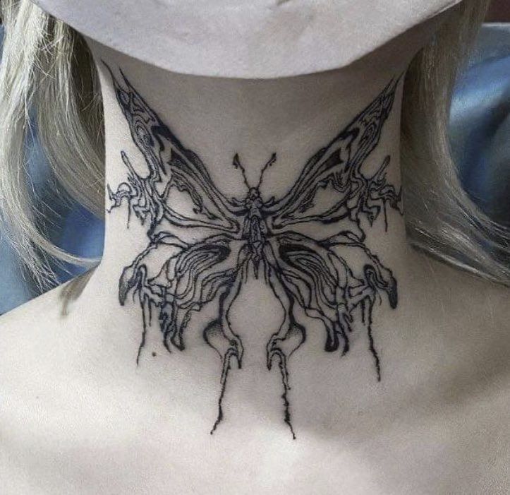 a woman's neck with a butterfly tattoo on it