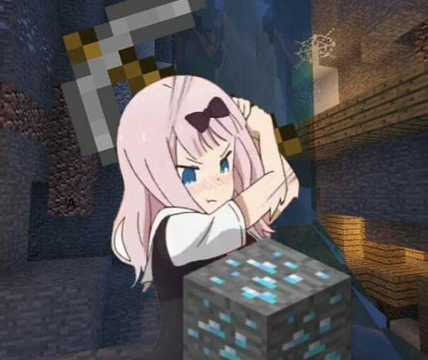 a girl with pink hair and glasses standing next to a block in a minecraft environment