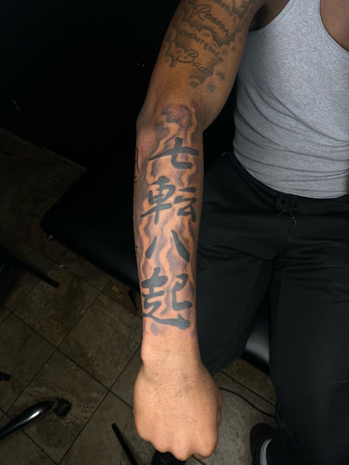 a man with a tattoo on his arm