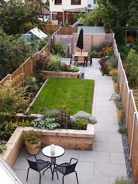 an outdoor garden with tables and chairs