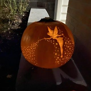 a carved pumpkin sitting on top of a window sill next to a door way