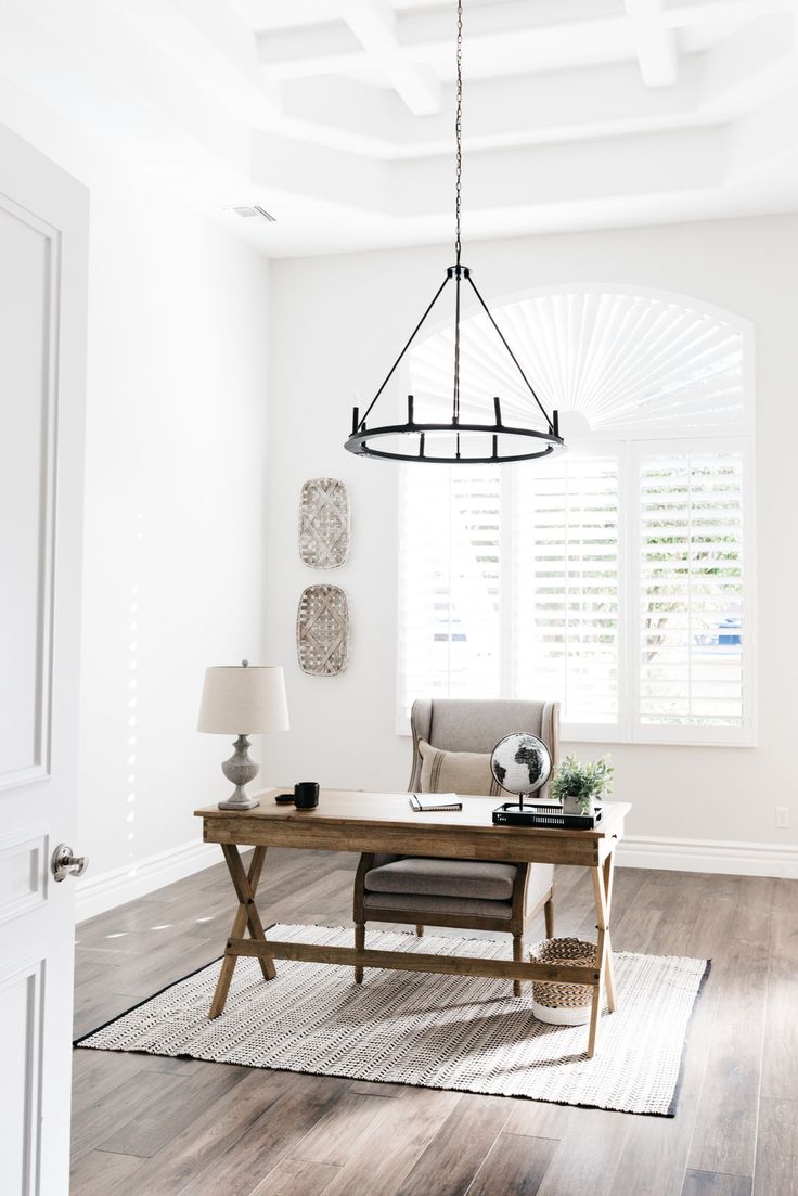 a living room with white walls and wooden floors