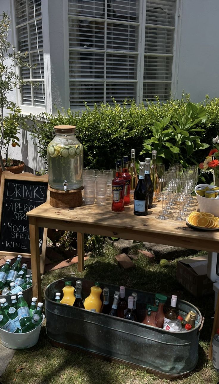 a picnic table with drinks and snacks on it