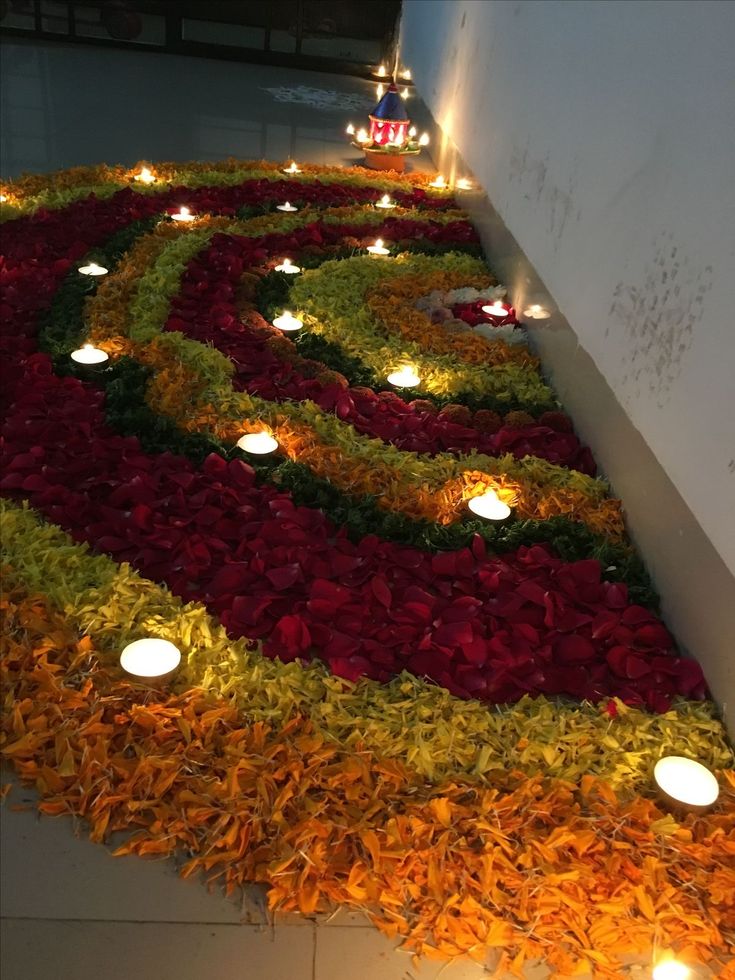 flowers and candles are arranged in the shape of a spiral